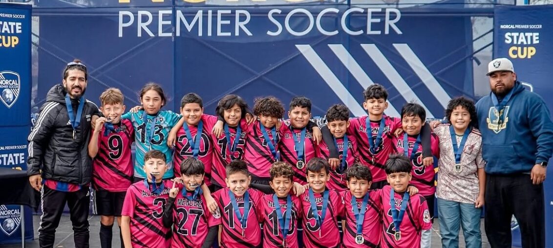 U12 San Pablo Lobos youth soccer team celebrating their championship win in the U12 Platinum Cup at the NorCal State Cup.