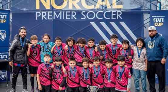 U12 San Pablo Lobos youth soccer team celebrating their championship win in the U12 Platinum Cup at the NorCal State Cup.