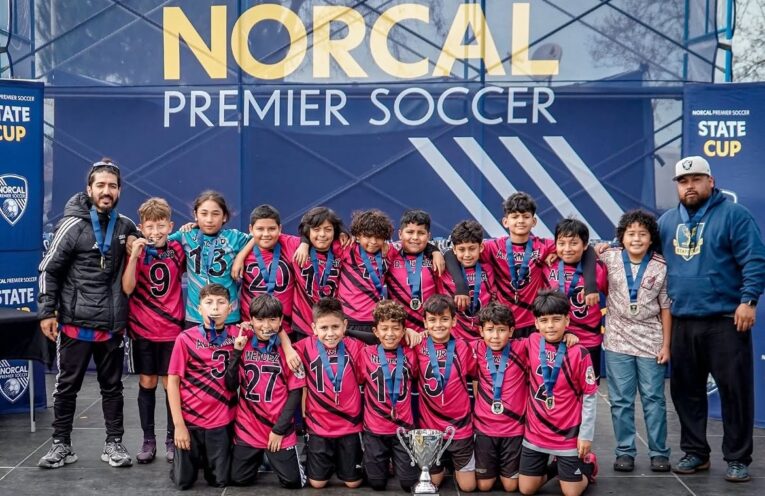 U12 San Pablo Lobos youth soccer team celebrating their championship win in the U12 Platinum Cup at the NorCal State Cup.